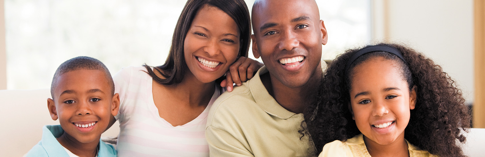 Young African American family on couch smiling