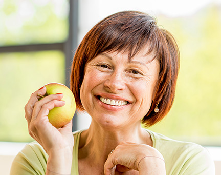 woman holding apple